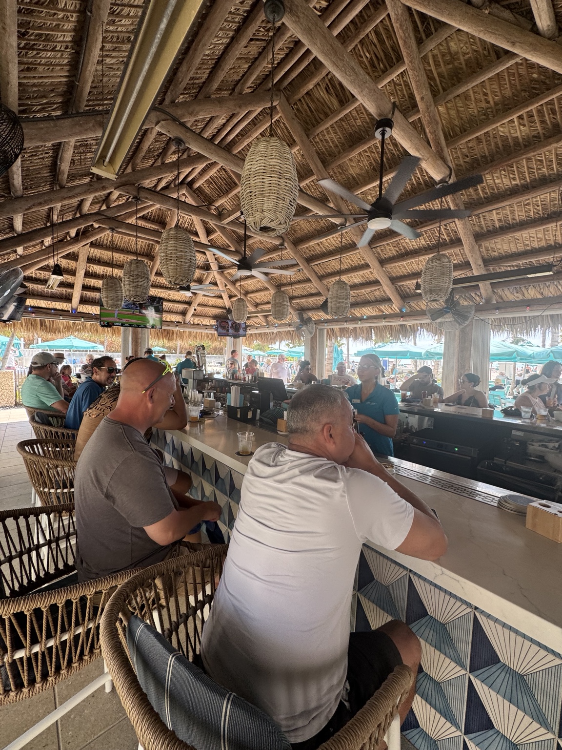 Guests relaxing at the open-air Tiki Bar at Lido Beach Resort