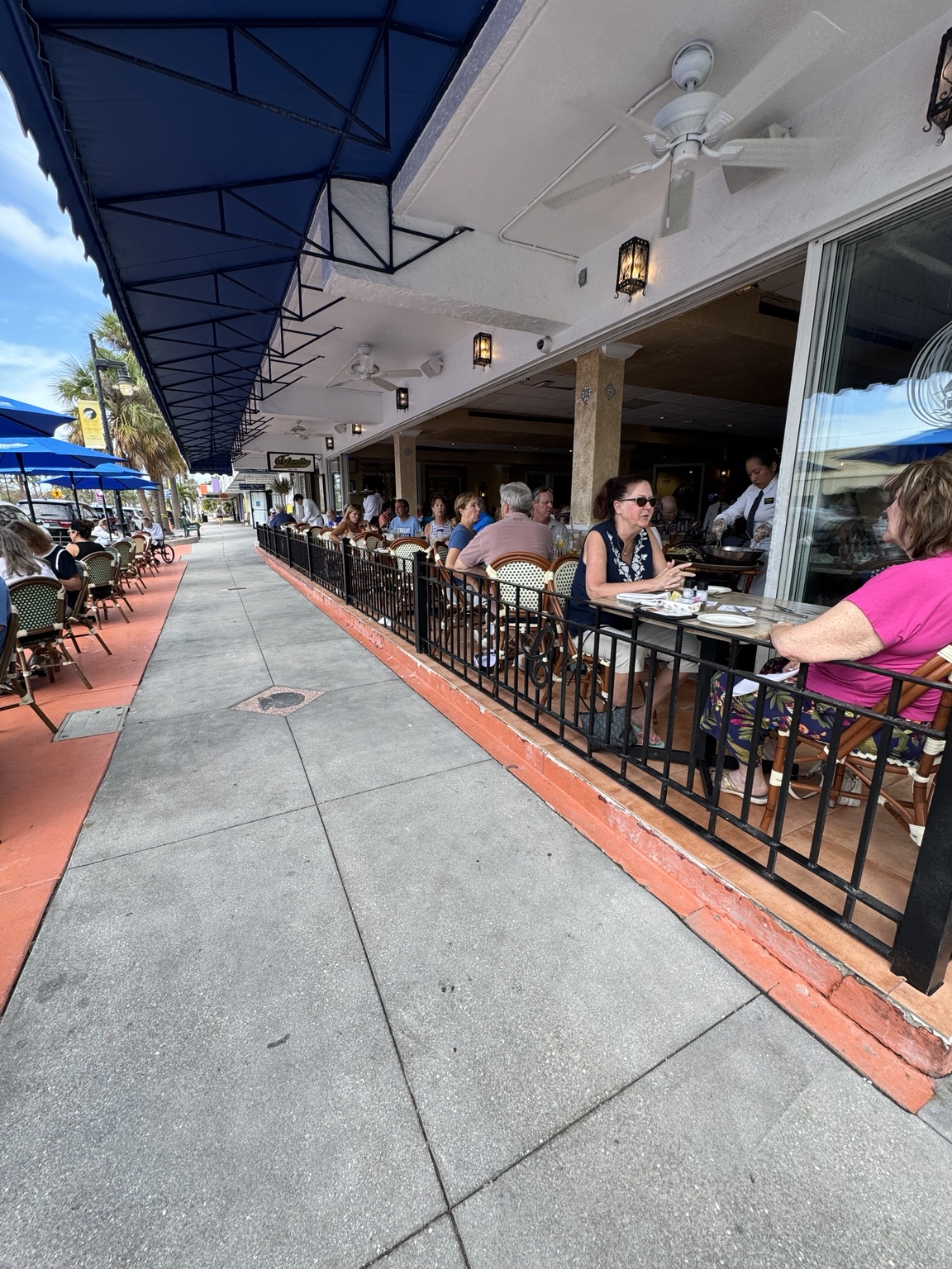 Sidewalk tables filled with diners at St. Armands Circle