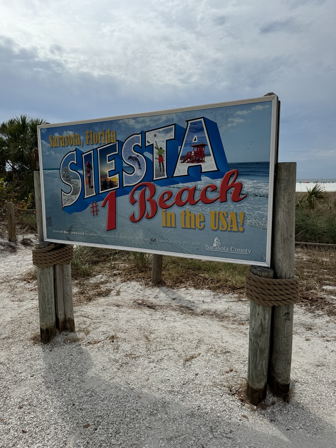 Colorful Siesta Beach number one beach sign beside the Gulf