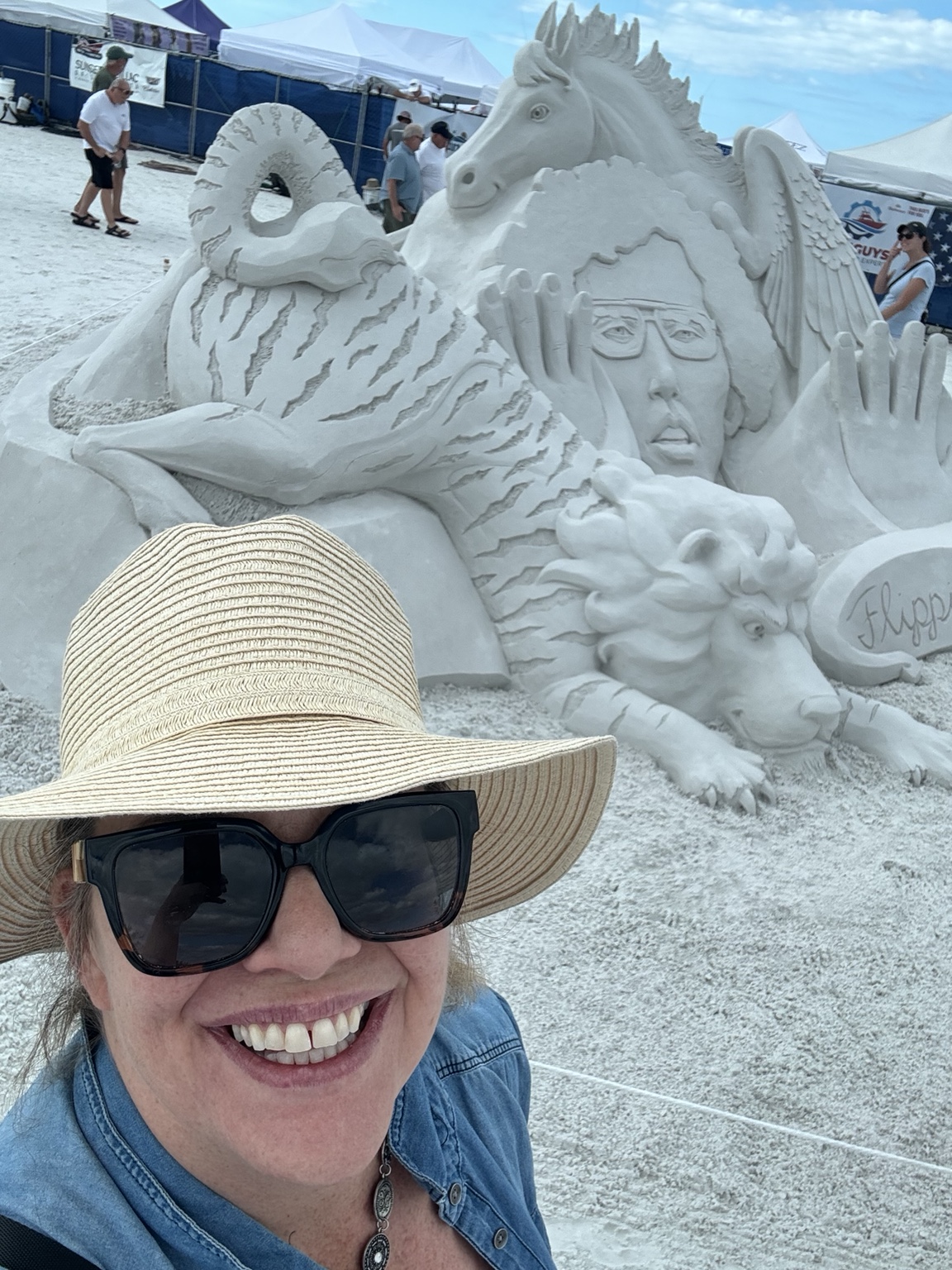 Mary Beth beside a Crystal Classic sand sculpture